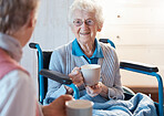 Senior, wheelchair and woman patient with morning coffee in a consulting medical conversation. Mobility disability, healthcare and retirement nursing home female happy talking to a caregiver nurse