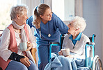 Nursing home, care and nurse with senior women doing healthcare checkup, examination or consultation. Medical, conversation and elderly woman in wheelchair consulting a doctor at retirement facility.