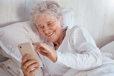 Buy stock photo Happy elderly woman, bed or phone on social media for meme, comic or joke on internet. Senior lady, bedroom or smartphone tech with laugh at social network, funny video or email on web, app or online