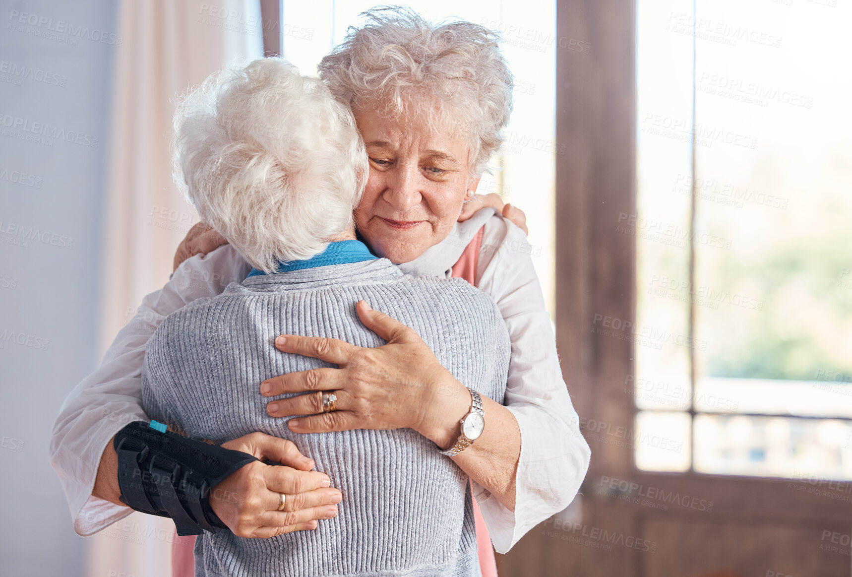 Buy stock photo Elderly women, hug and nursing home, friends and support, comfort and care, together with bond. Senior people hugging, retirement and love with friendship in retirement home and connection.