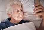 Phone, face and morning with a senior woman waking up in bed in the bedroom of her retirement home. Contact, social media and early with a mature female checking her mobile messages in the house