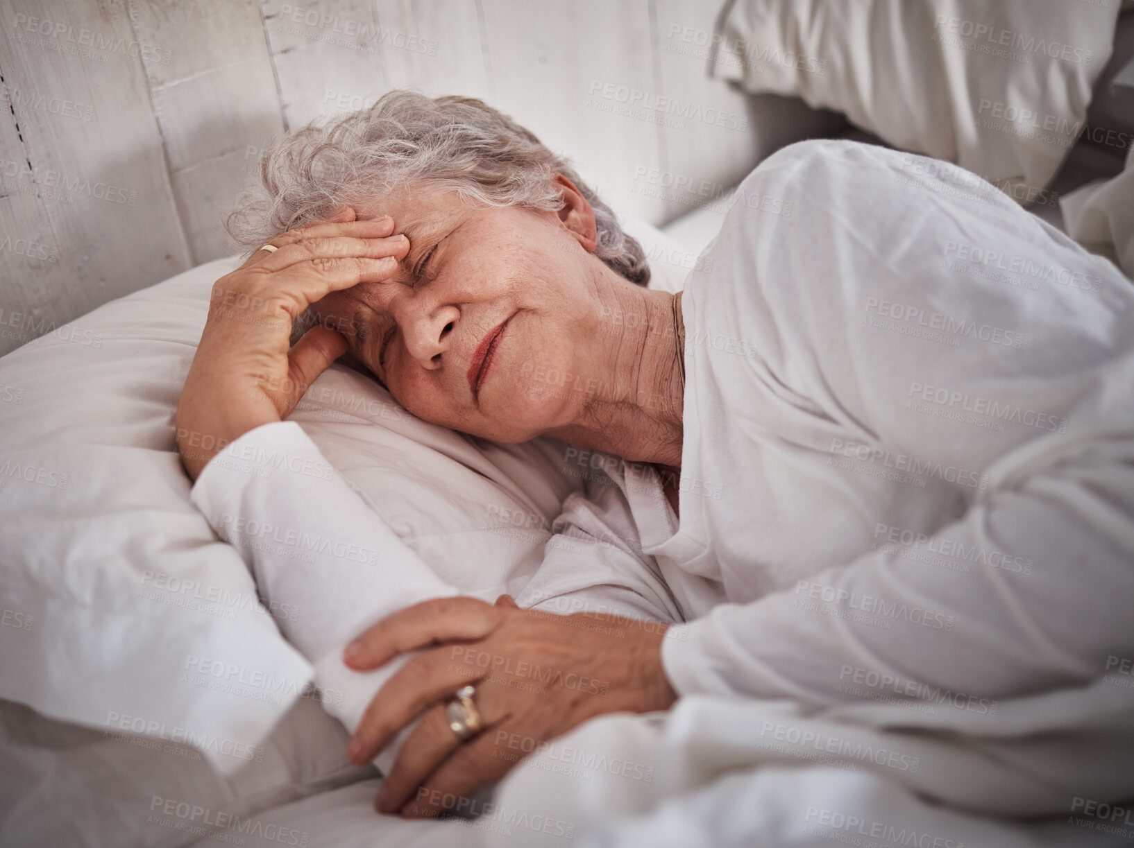 Buy stock photo Elderly woman, sleeping and bed with headache to rest mind, tired body and dreaming for wellness in house. Senior lady, home bedroom and pain while lying in room for health, retirement or stress