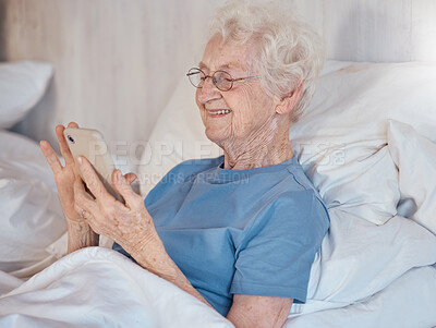 Buy stock photo Elderly woman, retirement home and smartphone in bed of nursing home for medical care to relax to support healthcare. Senior with happy smile, in hospital bed and rehabilitation for physical health 
