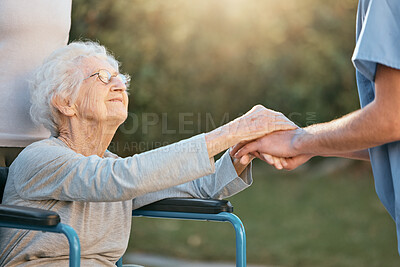 Buy stock photo Elderly woman, wheelchair and caregiver holding hands for support, care and solidarity in nature park. Senior person, patient disability and healthcare nurse communication in retirement home outdoor