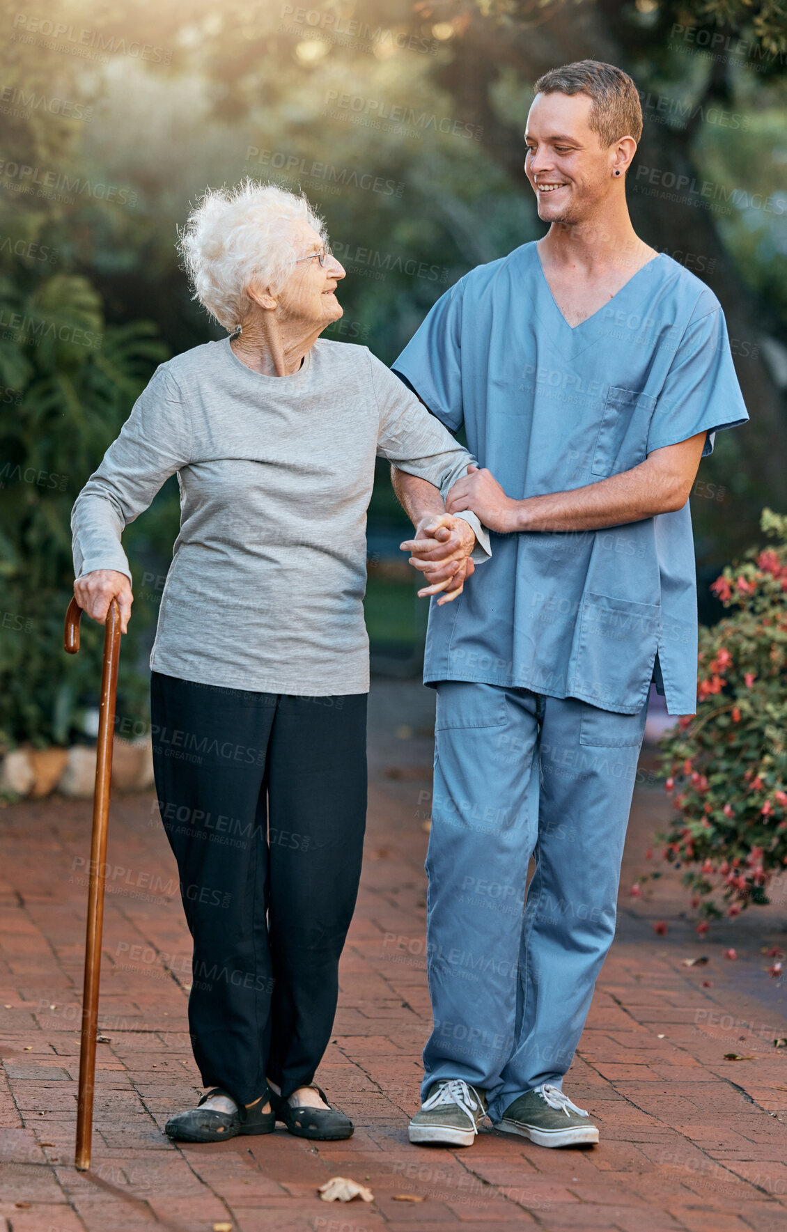 Buy stock photo Nurse, senior woman and walking in park for healthcare and wellness. Physiotherapy, rehabilitation and retired elderly female with disability and cane talking to medical worker outdoors in garden.