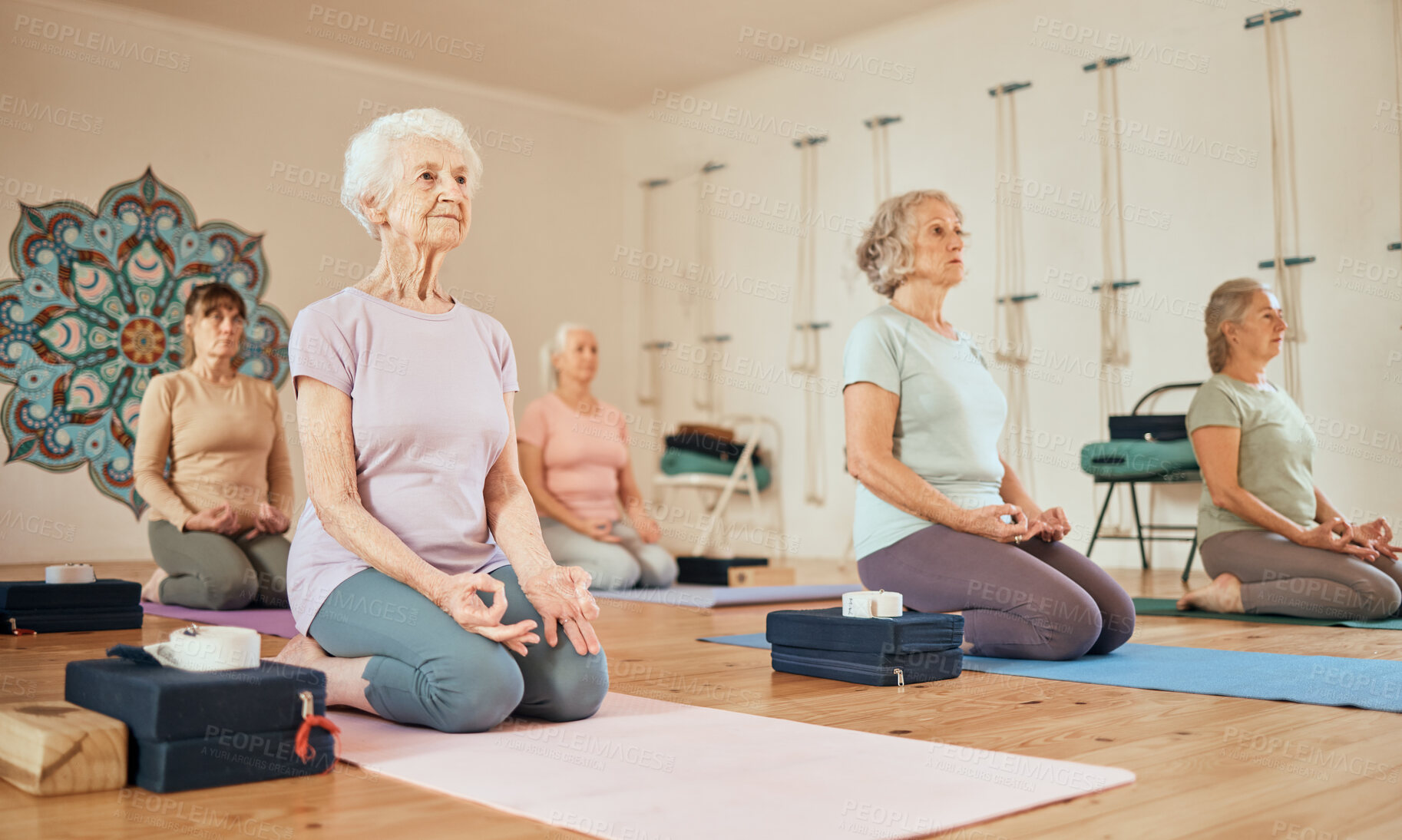 Buy stock photo Yoga, lotus and group of senior women in gym meditating for spiritual health and wellness. Meditation, zen chakra and retired females training to relax for mindfulness and peace in fitness center.
