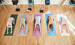 Yoga, studio and group of senior women in retirement doing a stretching exercise for body and mind. Wellness, health and elderly friends doing pilates workout for balance, peace and fitness in class.