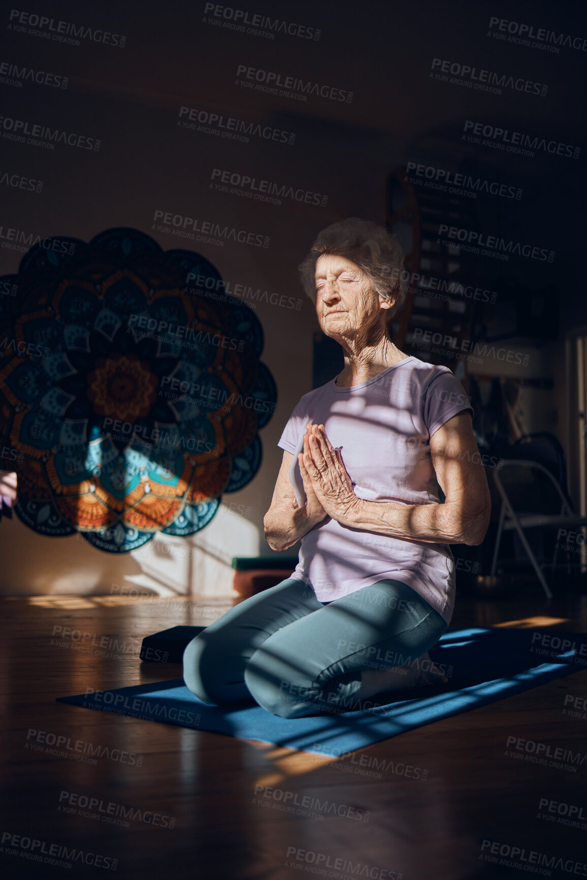 Buy stock photo Meditation, zen and elderly woman doing yoga in dark room, shadow and positive energy, balance and mindfulness. Wellness, spiritual and stress relief, calm and peace of mind with fitness and exercise