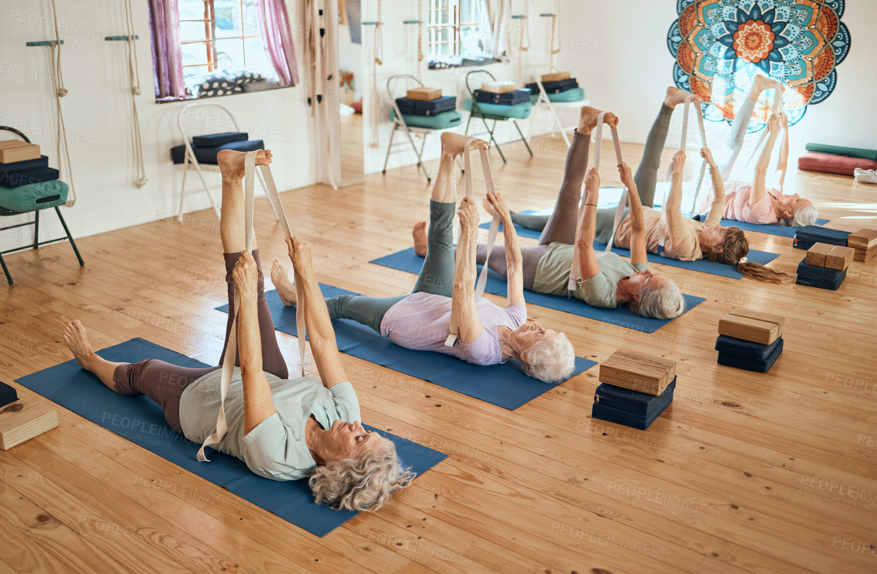 Buy stock photo Yoga, stretching and senior women training body for health, exercise and fitness on the floor of a gym. Wellness, relax and group of elderly friends in a workout class for pilates and rehabilitation