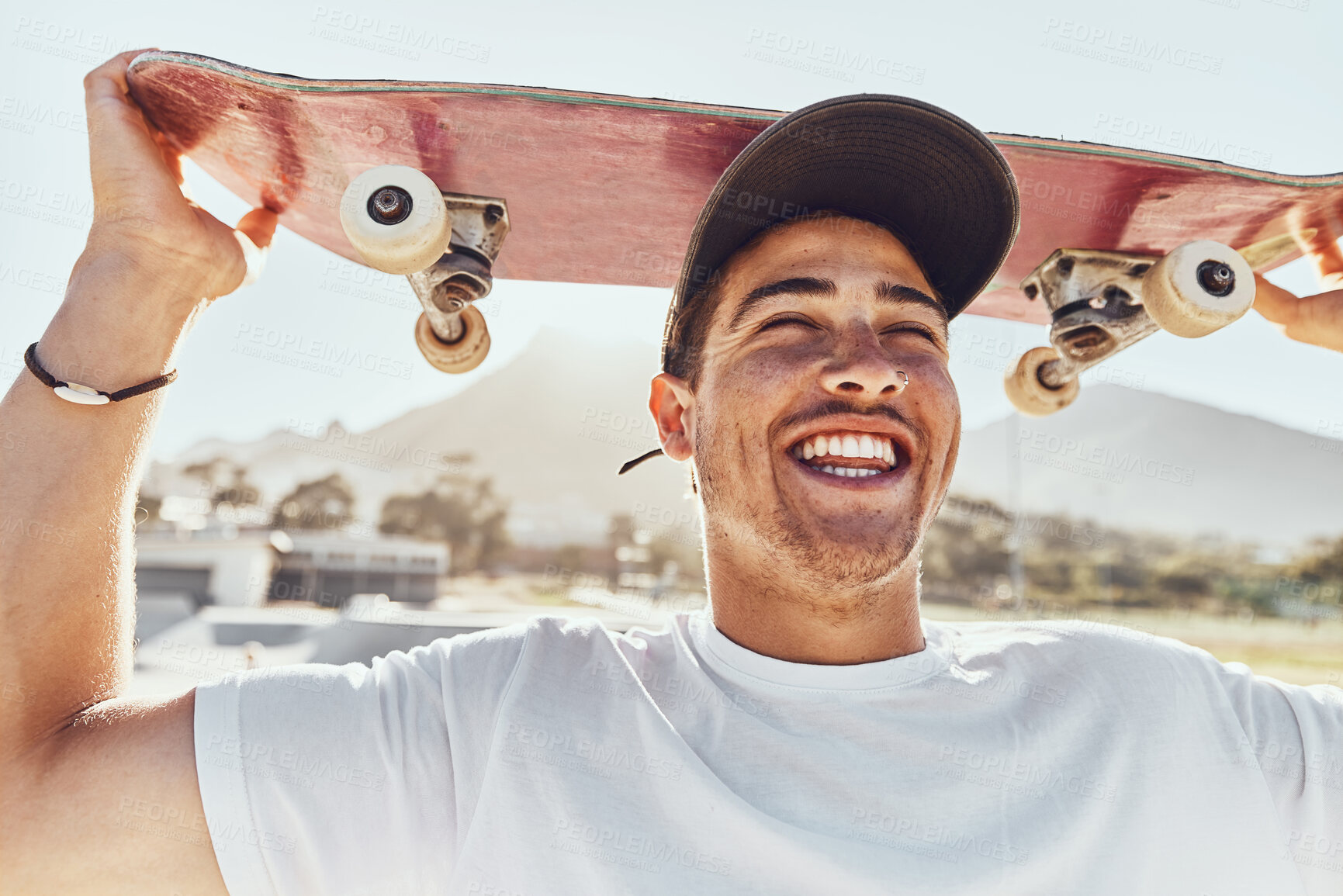 Buy stock photo Skateboard, man and smile for happiness, outdoor and confident for holiday, relax and happy. Skater, young male and wellness enjoy casual day, being edgy and trendy with break, cool and on weekend. 