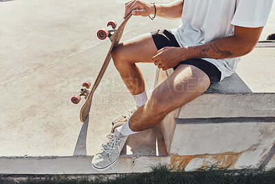 Buy stock photo Man, skateboard and sitting in park for training, sport or fitness in summer sunshine to rest. Skater guy, relax and urban skatepark for workout, wellness or skating exercise on concrete in metro