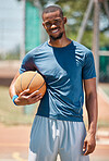 Basketball player, black man portrait and outdoor sports court training, workout and game in New York, USA. Happy professional male athlete, basketball court and ball, community playground and action