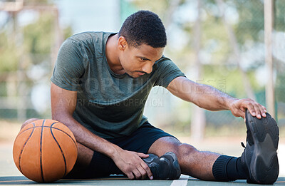 Buy stock photo Basketball, leg stretching and fitness of a man before exercise, training and outdoor workout. Health, wellness and game start of a athlete on a basketball court on the ground prepare with warm up 