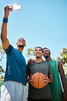 Phone, basketball and team taking a selfie on court after a match, training or practice. Fitness, sports and African men athletes taking picture with smartphone on outdoor basketball court after game