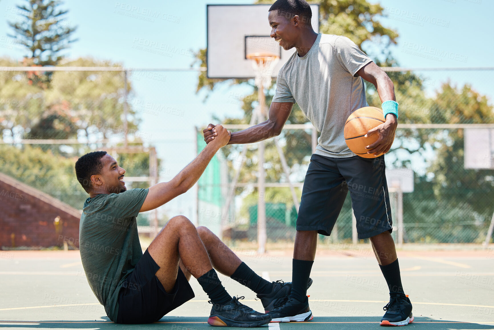 Buy stock photo Basketball, sports and teamwork, helping hand and support, respect and assistance in competition training games. Happy basketball player holding hands with friend, trust and kindness on outdoor court