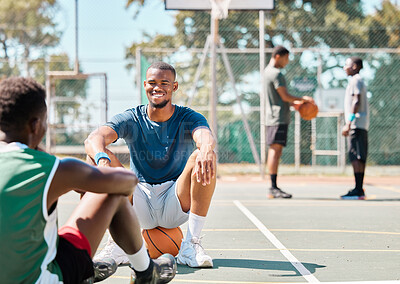 Buy stock photo Basketball, team sports and social conversation at the court for break after fitness, training or exercise match. Happy basketball players talking, discussion or relaxing on the basketball court