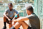 Basketball, sport and athlete friends talk after training, exercise and sports outdoor. Game conversation on the basketball court ground talking about team strategy on a relax break from fitness
