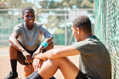 Buy stock photo Basketball, sport and athlete friends talk after training, exercise and sports outdoor. Game conversation on the basketball court ground talking about team strategy on a relax break from fitness