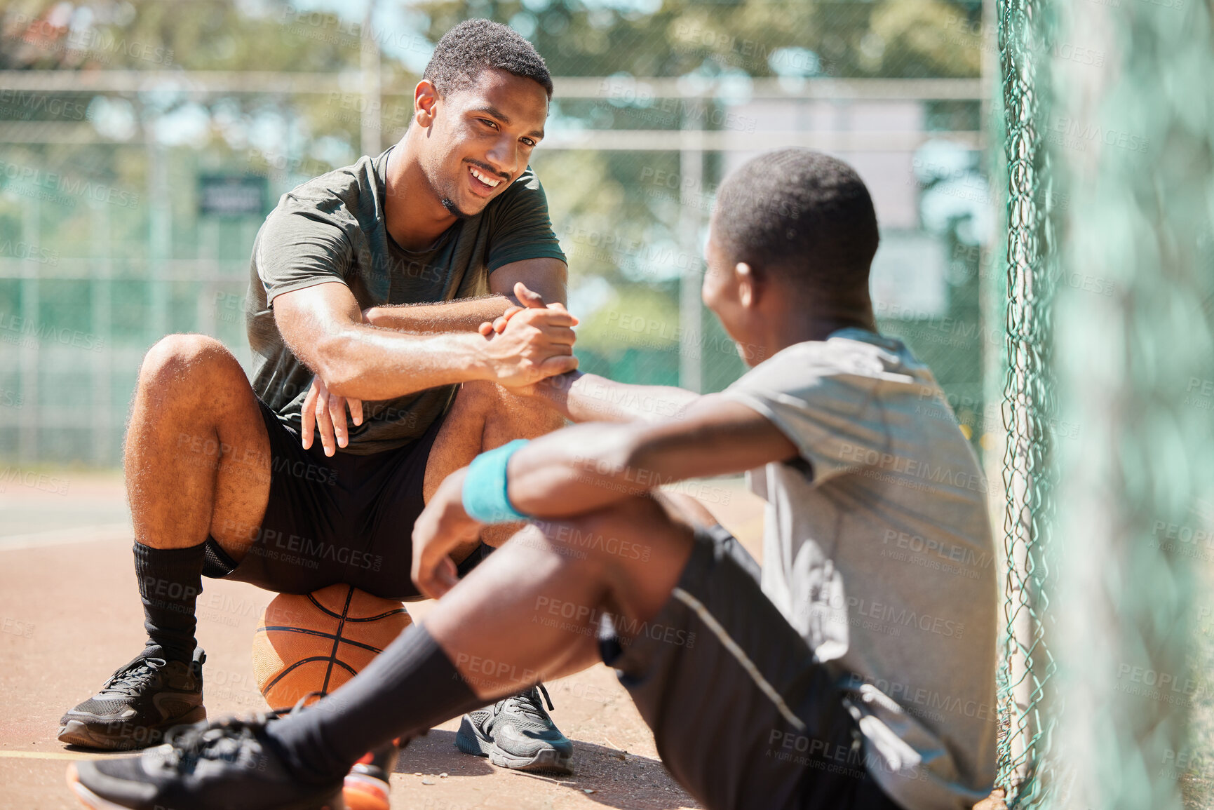 Buy stock photo Teamwork, sports and friends with black man on basketball court holding hands for support, congratulations and training. Fitness, help and community with basketball player for game, respect or faith
