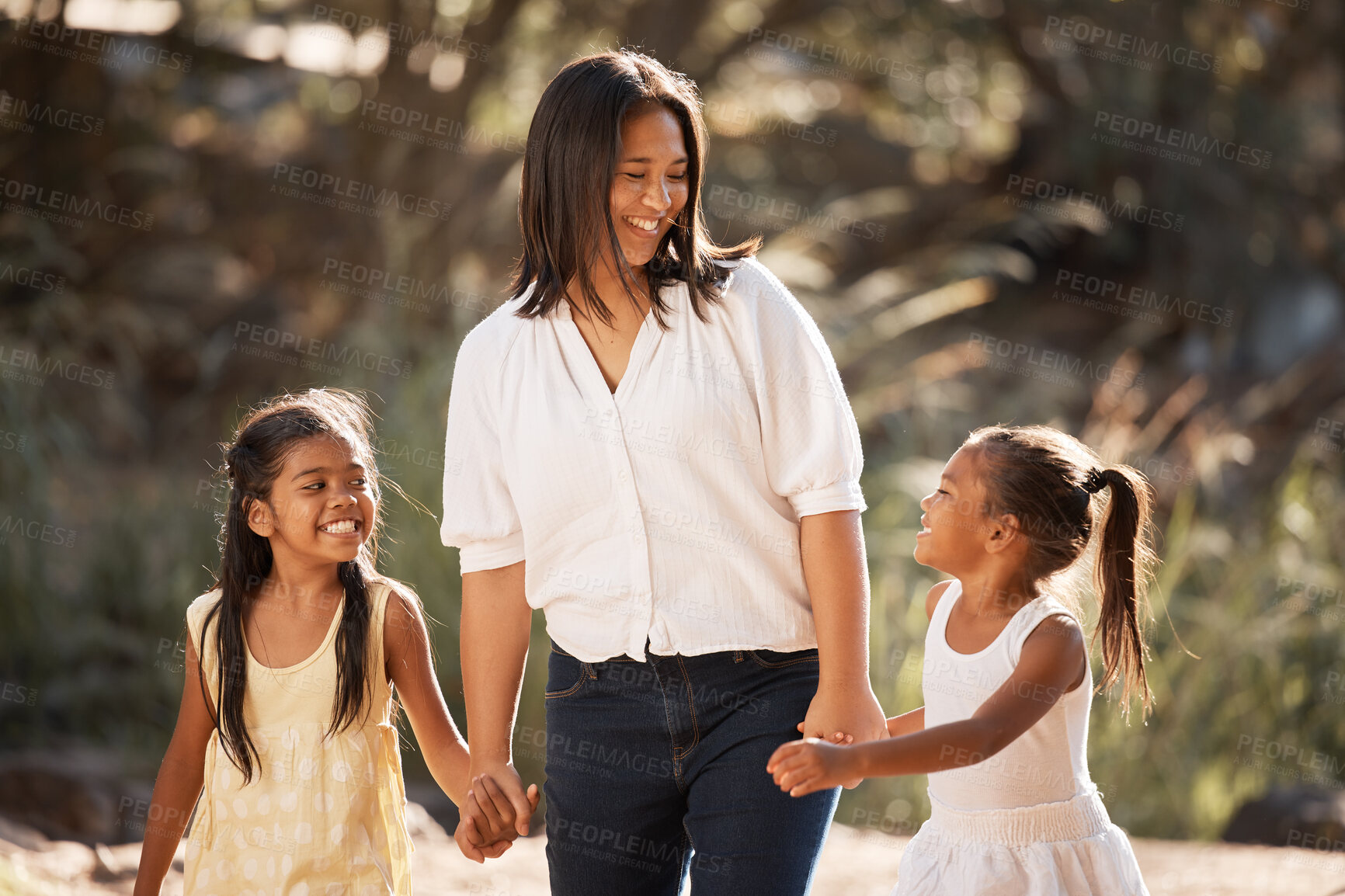 Buy stock photo Family, children and holding hands with a mother and daughter siblings walking outdoor together in nature. Kids, love and happy with a woman, girl and sister taking a walk hand in hand while bonding