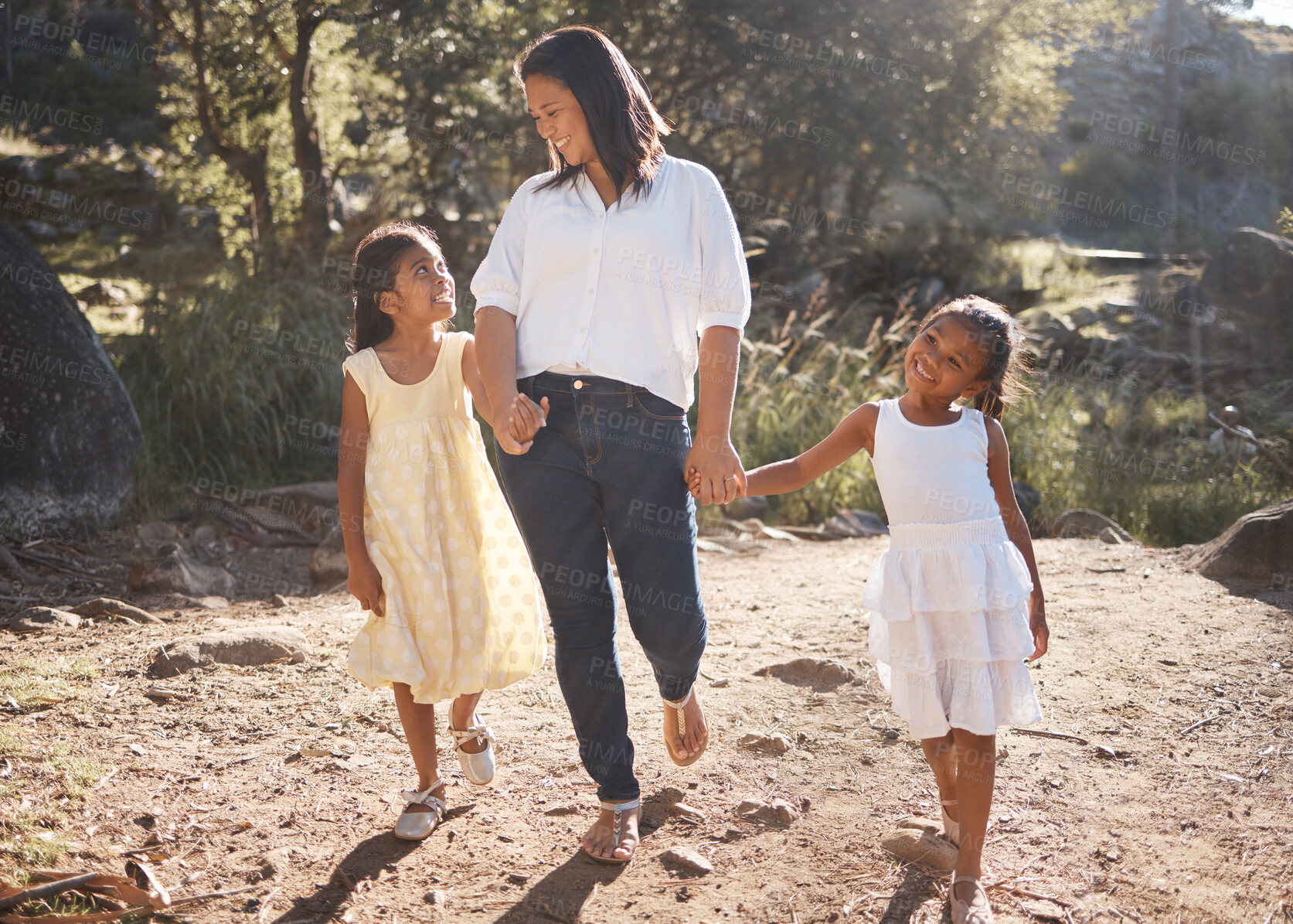 Buy stock photo Mother and children holding hands while walking in nature on adventure, hiking or family bonding trip on mothers day. Woman outdoor at park for travel with daughters or girl kids for love and support