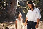 Happy, child and mother walking in nature holding hands, bonding or talking as mother and daughter outdoors. Smile, happy family and young girl enjoys quality time with a lovely mama or mom in Peru