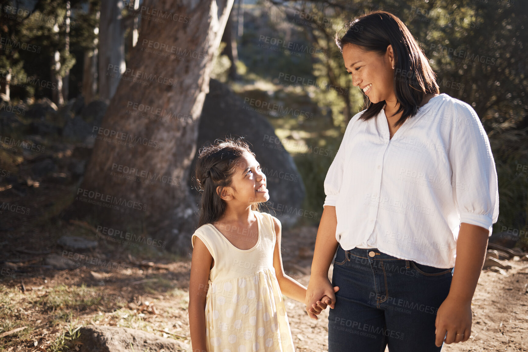 Buy stock photo Happy, child and mother walking in nature holding hands, bonding or talking as mother and daughter outdoors. Smile, happy family and young girl enjoys quality time with a lovely mama or mom in Peru