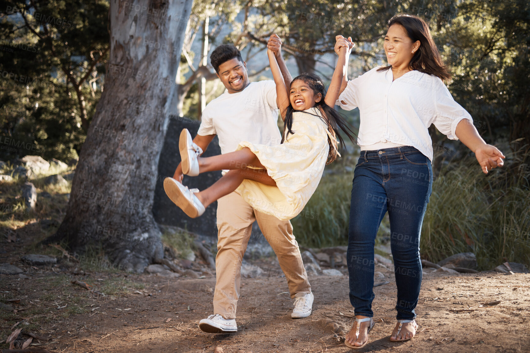 Buy stock photo Family, nature and parents holding hands with girl enjoying holiday, weekend and summer vacation together. Love, happiness and mom and dad lifting young child playing, walking and bonding in park