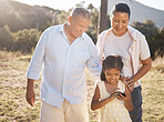 Phone, family and nature with a girl and grandparents outdoor together during summer vacation. Social media, love and care with a senior man and woman bonding with their female grandchild outside