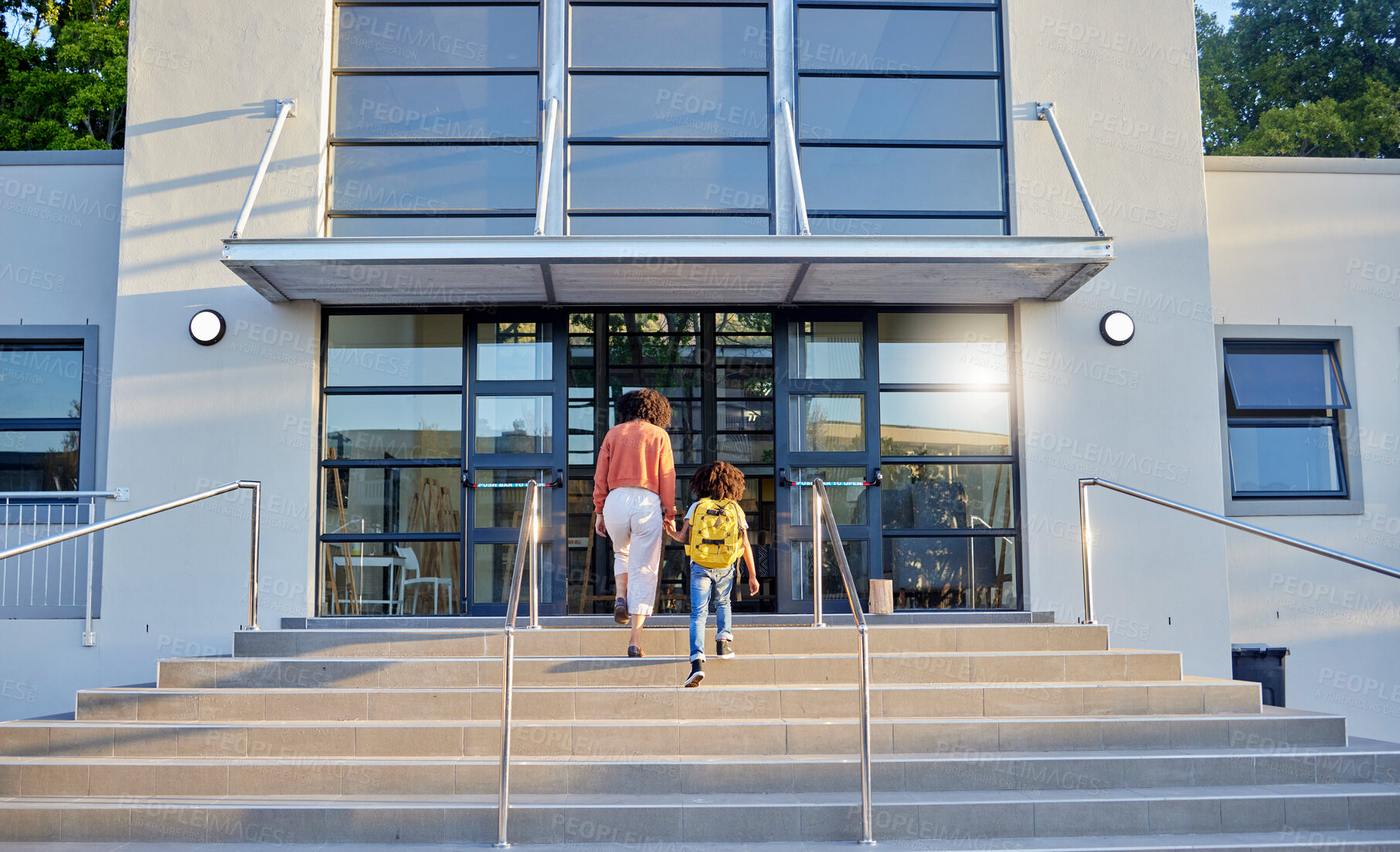 Buy stock photo School, education and mother walking with child in morning for learning, child development and class. Support, love and mom and kid holding hands on steps of campus entrance for back to school