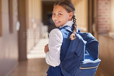 Buy stock photo Education, backpack and learning with a school girl walking down a corridor to class to study for development. Children, student and portrait with a female kid in an academic building for knowledge