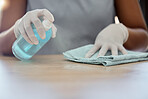 Cleaning, table and woman with spray bottle, cloth and dusting furniture in home. Closeup hands of cleaner, housekeeper and maid, surface disinfection and liquid detergent product for bacteria safety