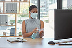 Covid, mask and hand sanitizer with a business black woman cleaning while working in her office. Health, safety and sanitizing with a female employee using disinfectant during the corona virus