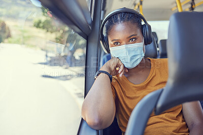 Buy stock photo Travel, face mask and black woman with headphones on a bus driving to work during a pandemic. Public transport, covid and African girl listening to music, radio or podcast while on a journey or trip.