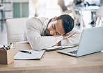 Man, tired and sleep at office desk with computer, notebook or exhausted at startup finance job. Worker, burnout and sleeping at work table in workplace with laptop, book or overworked in accounting