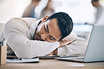 Tired, burnout and businessman sleeping on desk in corporate office after working on laptop. Stress, headache and male worker asleep with head on table with notebook and computer, exhausted from job