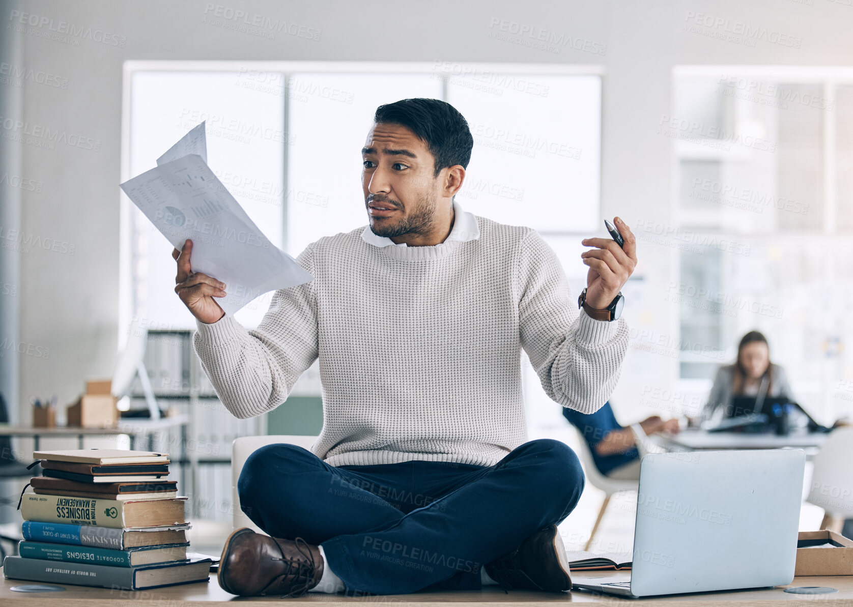 Buy stock photo Student, stress and mental health, paper and anxiety while sitting on table in education hall, laptop and studying. Young man, study and frustrated while learning university, college or school campus 