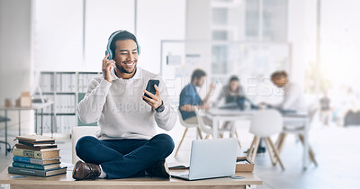 Buy stock photo Man, music headphones and relax at startup, office or workplace for digital marketing with smile. Happy worker, video and sitting on table with smartphone, laptop and reading social media at company