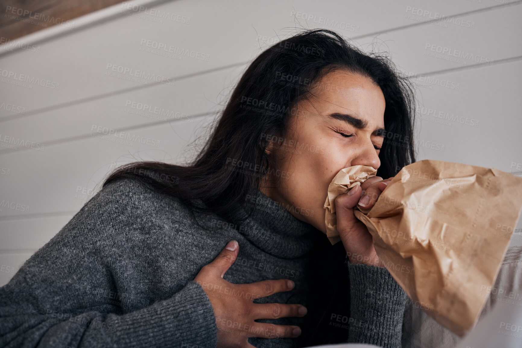 Buy stock photo Woman, anxiety and stress paper bag breathing of a woman with mental health problem or crisis. Hyperventilate, panic or fear of a female suffering from chest pain in a rehabilitation centre or home