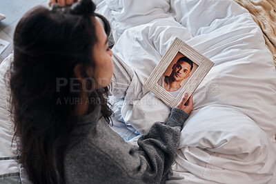 Buy stock photo Woman, sad and photo for widow on bed after death, funeral or loss of husband, partner or man. Grief depression, girl and picture memory of love, marriage or anxiety in home bedroom for mental health