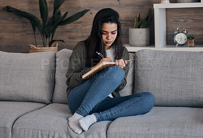 Buy stock photo Book, writing and woman on sofa for thinking, journal and creative, brainstorm and notes in a living room. Notebook, planning and girl on couch for diary entry, strategy and vision for future in home