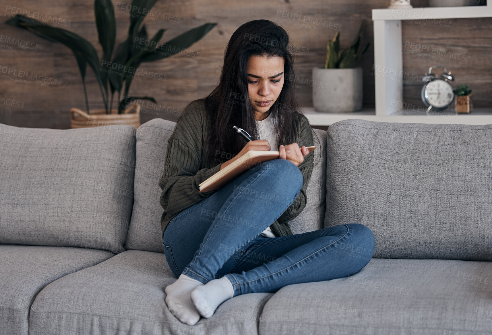 Buy stock photo Book, writing and woman on sofa for thinking, journal and creative, brainstorm and notes in a living room. Notebook, planning and girl on couch for diary entry, strategy and vision for future in home