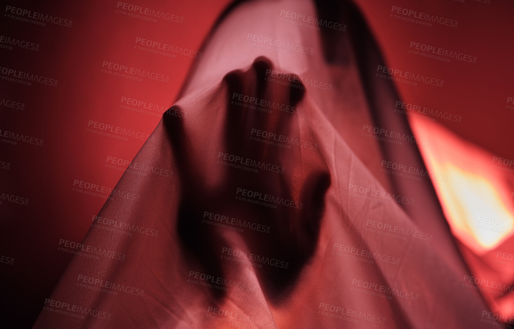 Buy stock photo Hand, fabric and red with a person under a sheet in a bedroom or studio on a red background for psychology. Hands, silhouette and shadow with an adult struggling with mental health, anxiety or fear