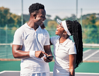 Buy stock photo Black couple, tennis and phone, laughing or smile for online communication or social media fitness. African man, woman and happy tennis player streaming comic video or workout motivation on court