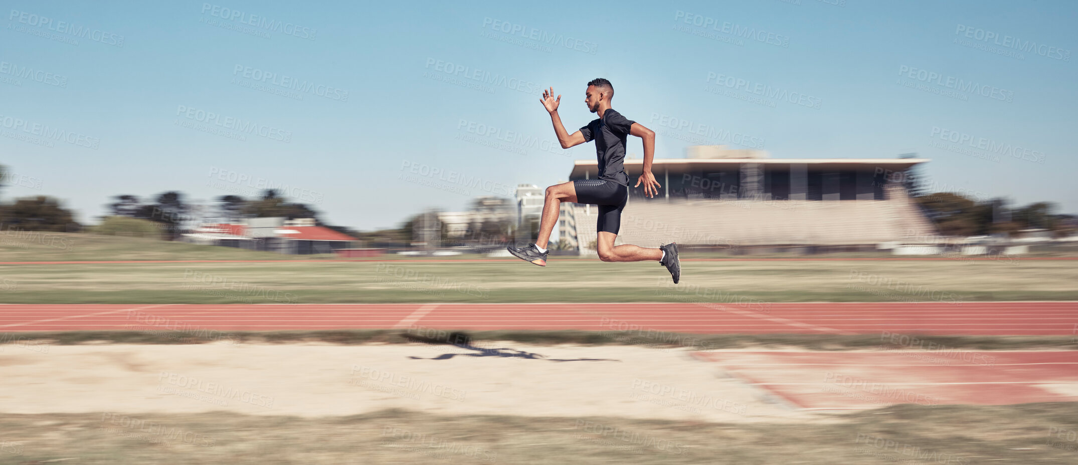 Buy stock photo Runner, man jump and sports stadium for marathon training, fitness workout or wellness exercise on track. Athlete, speed and running energy or jumping for olympics high jump performanc and challenge