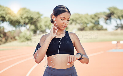 Buy stock photo Music, earphones and runner woman pulse check on workout, training and athlete break. Wellness, fitness and running girl pause at stadium track for performance analysis on smartwatch app.