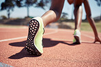 Runner, start race and closeup feet, legs or ready for competition, contest or sport event in sunshine. Athlete, training and running in position for fast speed on ground for success in summer run