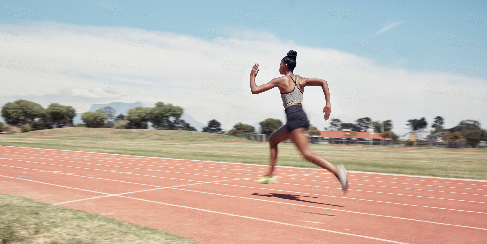 Buy stock photo Runner, fitness and fast black woman in stadium for professional race, competition or training. Sprint, performance and champion running athlete on sport ground with blur speed movement or motion.
