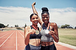 Portrait, success medals and women at stadium after winning running race or sports event outdoors. Fitness, winner and athlete friends happy with victory, goals or target achievement on track field.