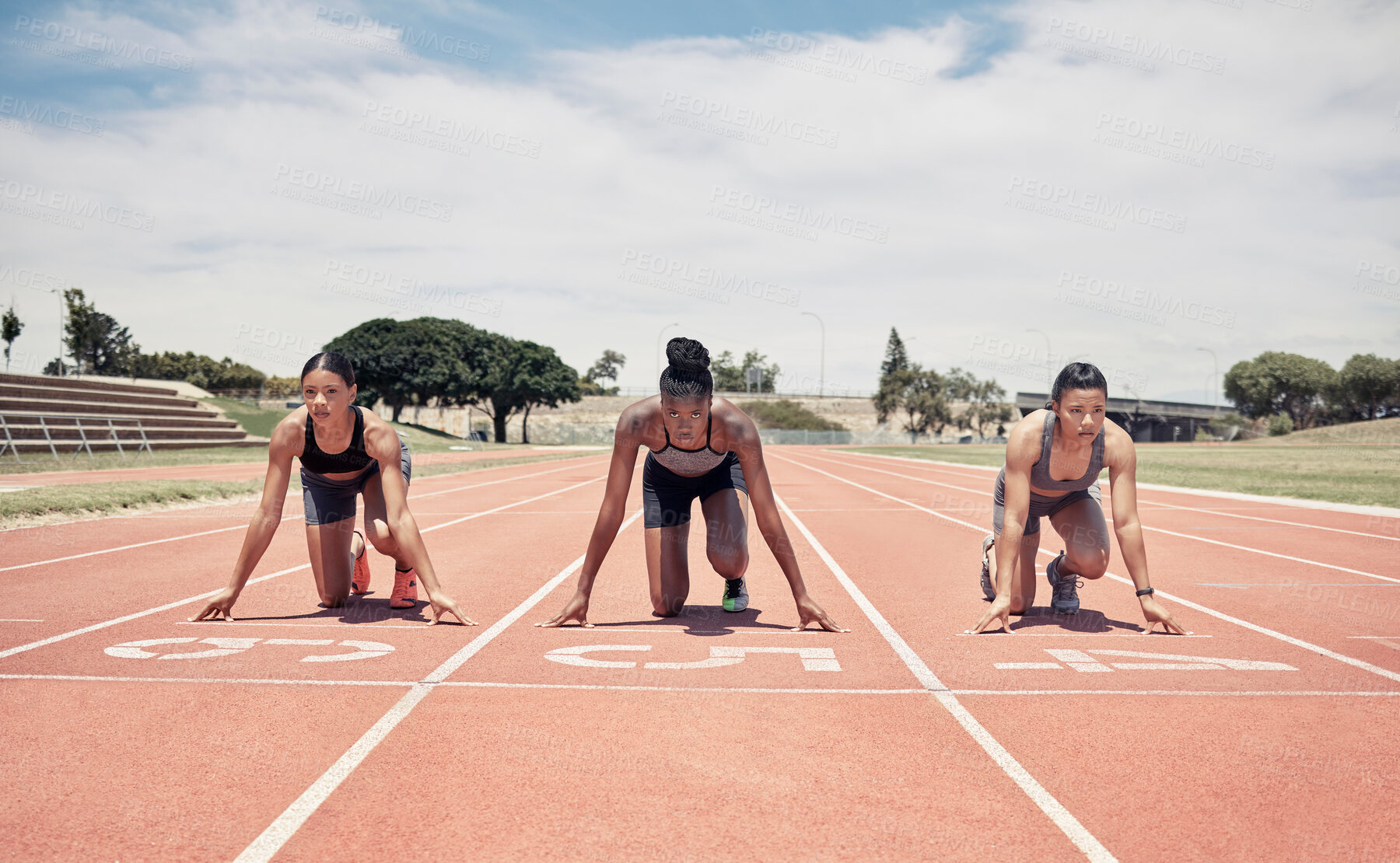 Buy stock photo Marathon, ready and sports women group or runner at a stadium race track for competition, game and event with focus, motivation and goal. International athlete people in line for a running challenge